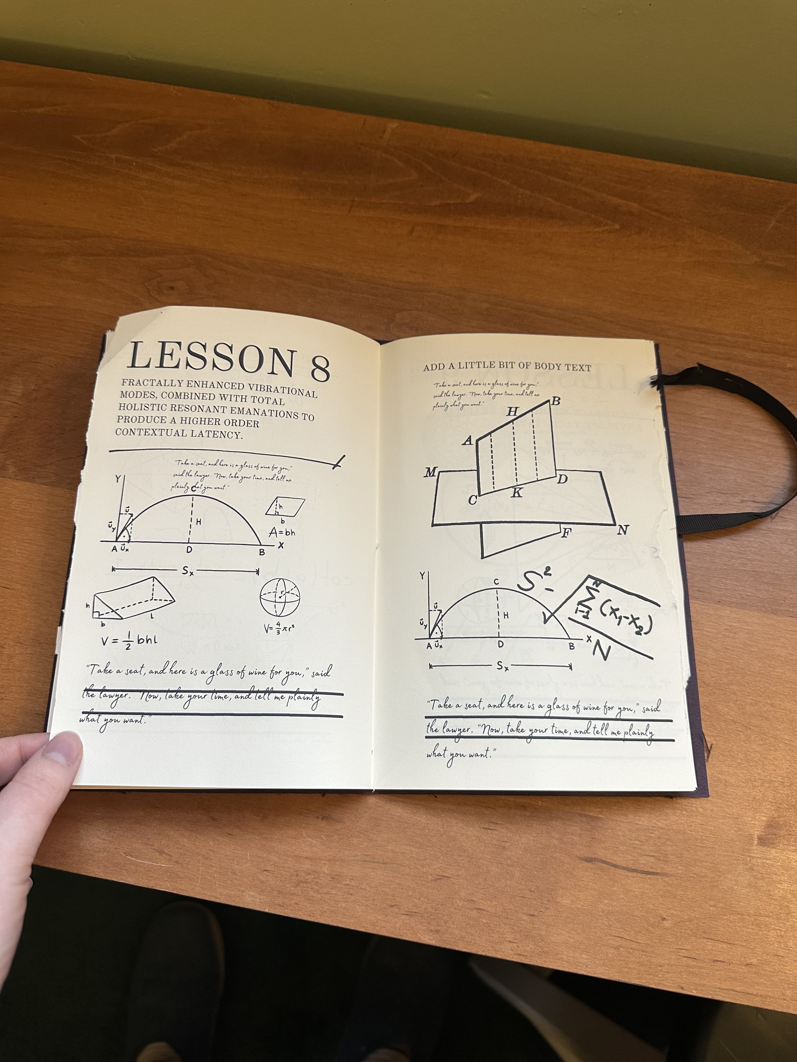 A hand opening the pages of what looks like a math study book. "Lesson 8" is readable at top. There are a lot of graphs and writing in it.