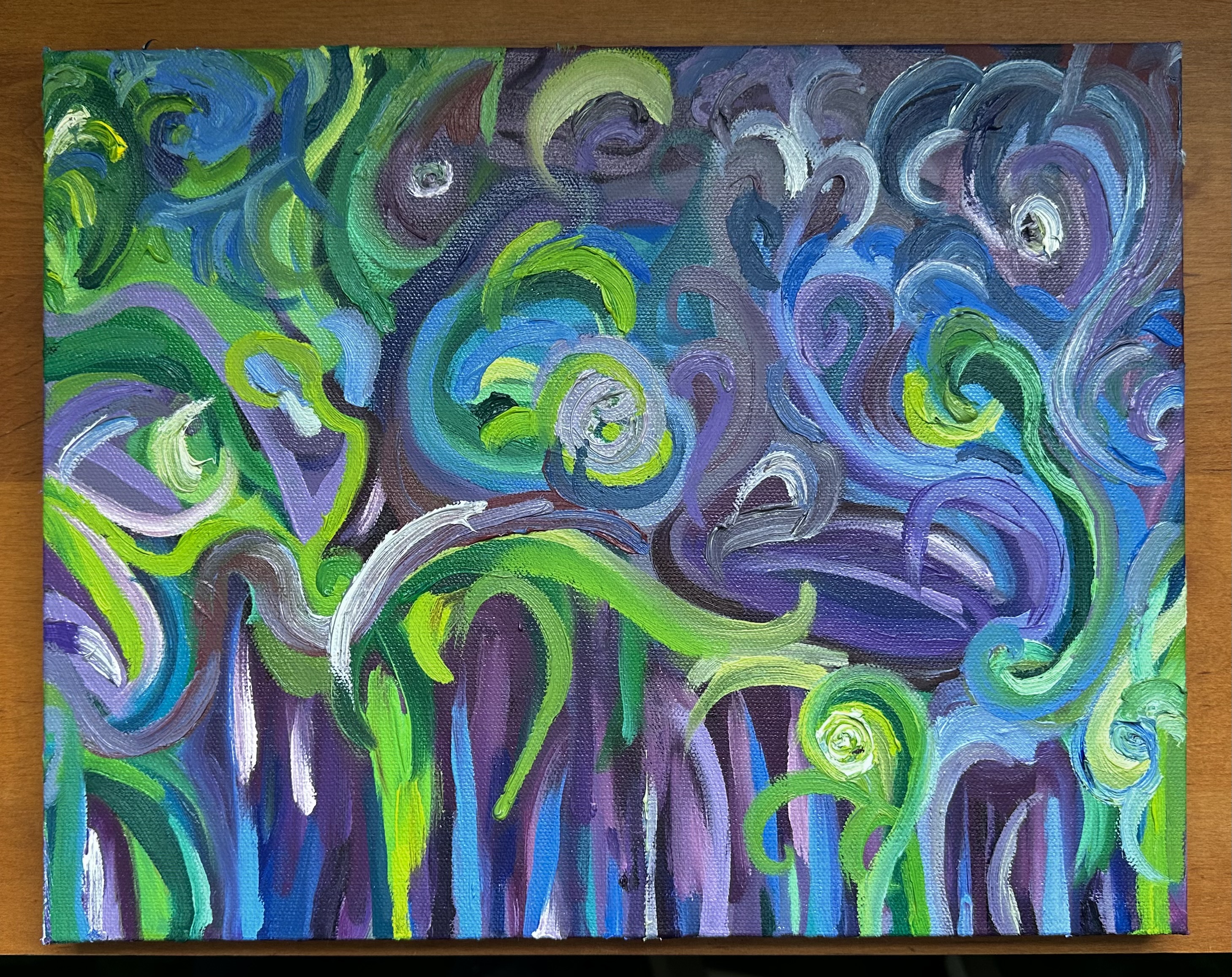 The front of an abstract painting made of up lines and swirls of green, purple, blue, and white.