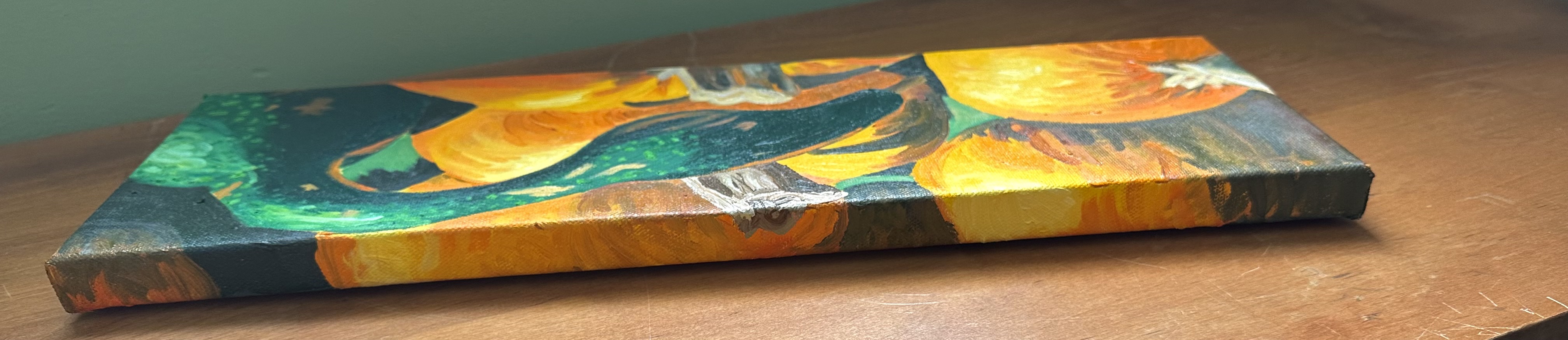 The top of the painting with a view of the front. The top shows more of the pumpkins in shadow and in light.