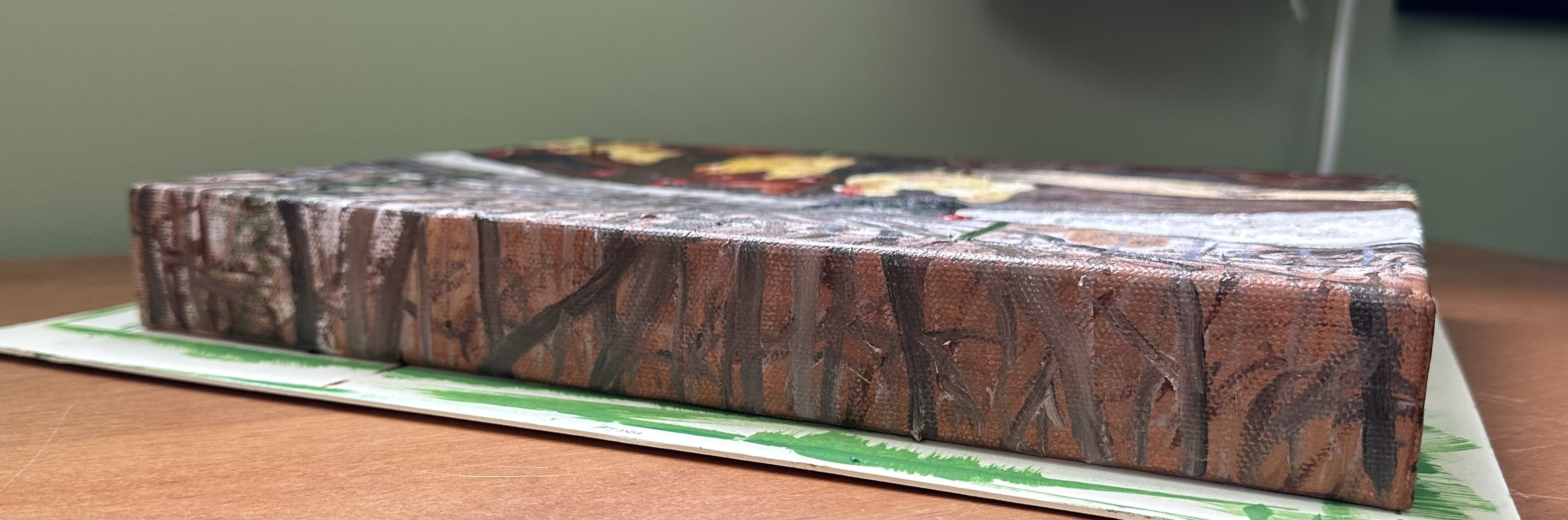 The top of the painting. It's entirely trees in the distance.